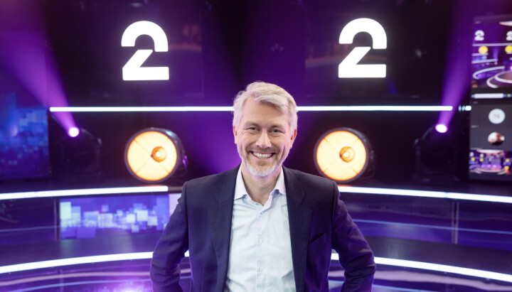 TV 2-sjef Olav T. Sandnes foran den nye logoen til TV2.